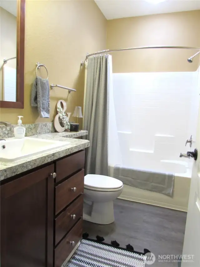 MAIN BATH W/ SKYLIGHT AND FULL TUB/SHOWER.