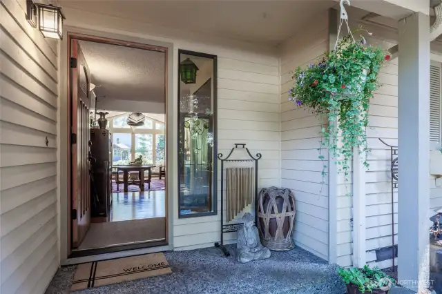 A welcoming front porch invites you to relax and take in the peaceful surroundings.