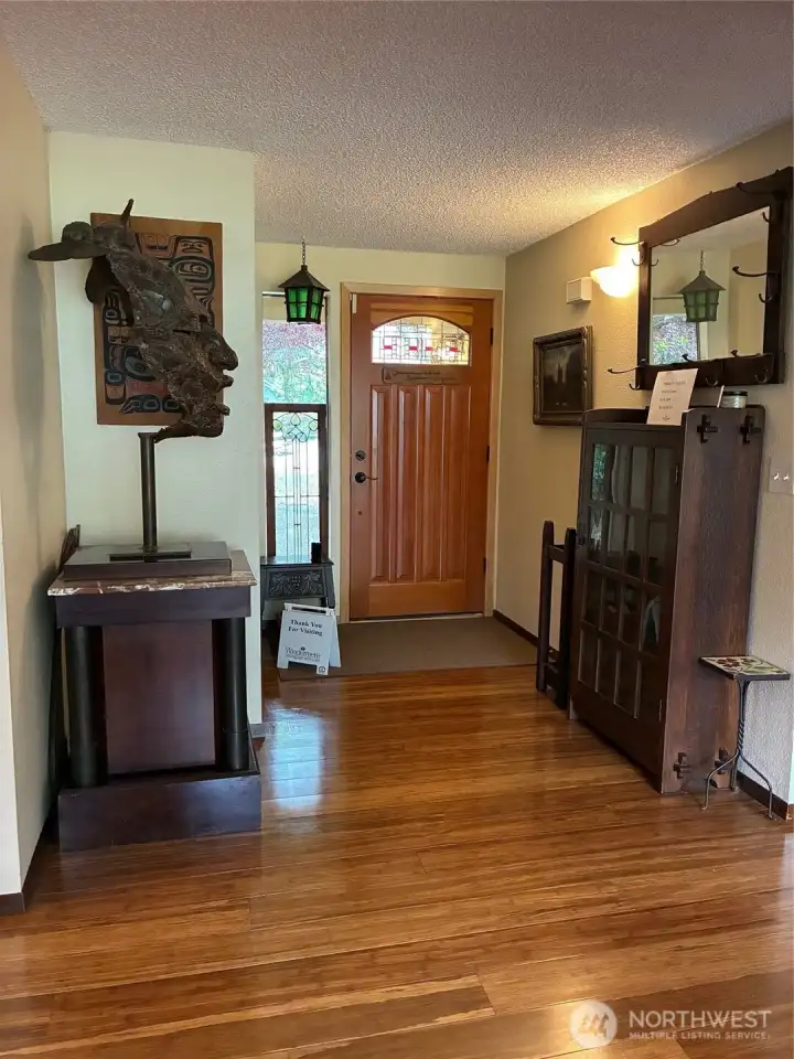 A spacious entry way with bamboo floors and coat closet