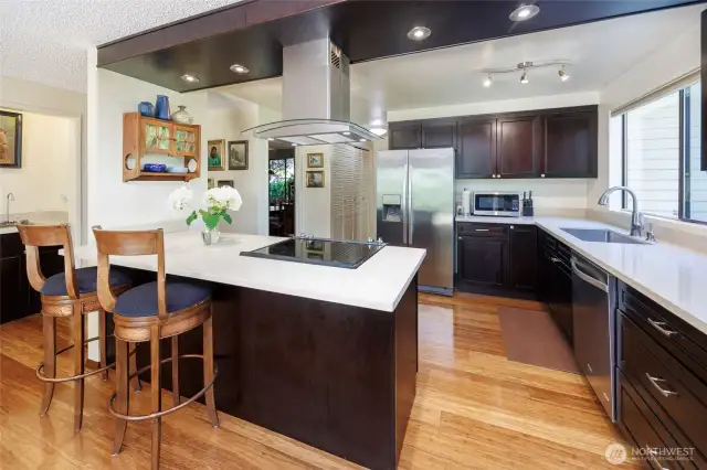 Updated kitchen is a chef's delight with bamboo floors, stainless appliances, quartz countertops plus a huge pantry
