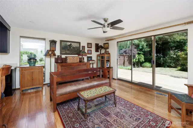 Generous family room with bamboo floors, wet bar, wood burning fireplace and oversized slider that steps out to the new deck with seating bench.