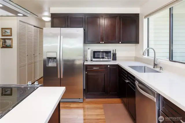 Updated kitchen is a chef's delight with bamboo floors, stainless appliances, quartz counter tops and huge pantry.