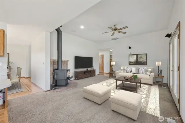 Family room with wood stove virtually staged