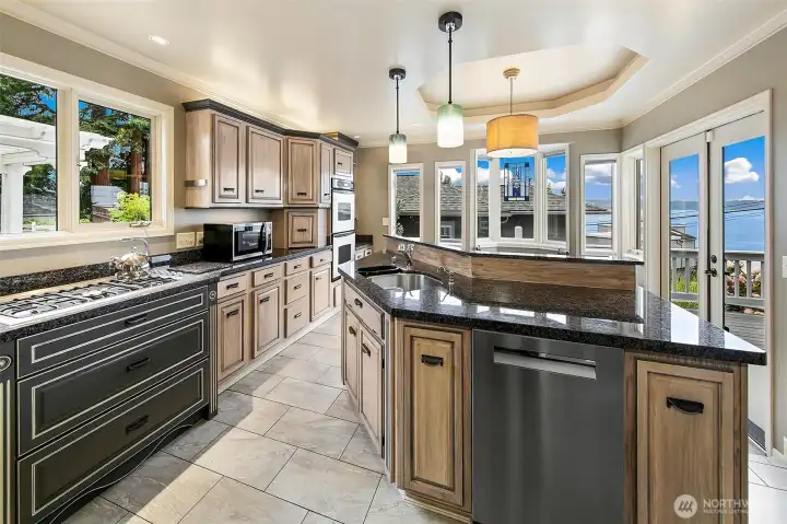 Kitchen with large rounded island and seating off the back side