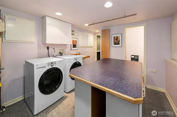 Laundry room is downstairs with plenty of folding space and storage.