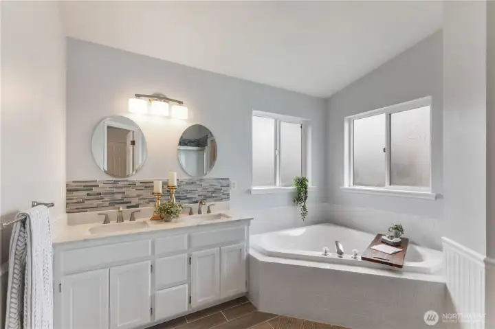 The 5-piece primary bathroom has been thoughtfully updated into a zen retreat.