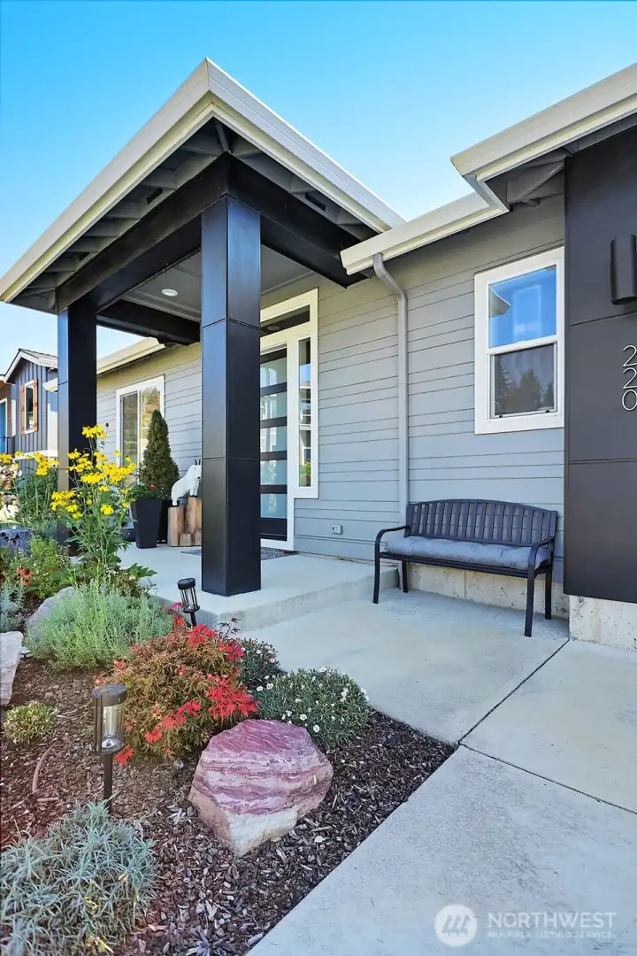 Front entryway to the home with only one step to access the entire main floor which includes the family room, kitchen, office and Primary bedroom.