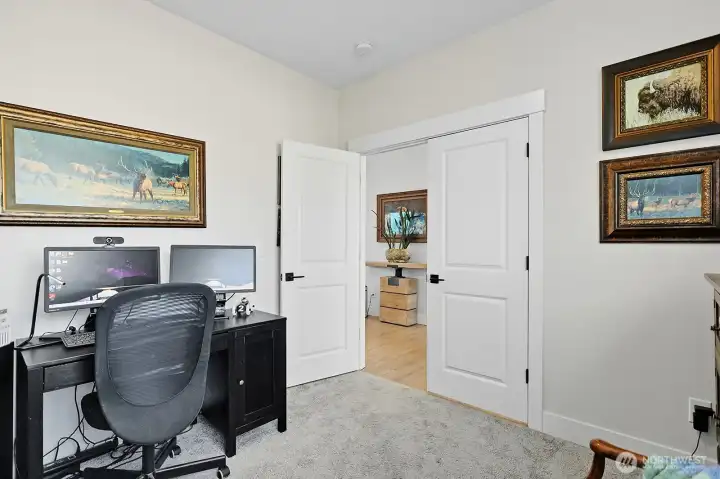 Main floor bedroom with closet could double as an office as shown here.