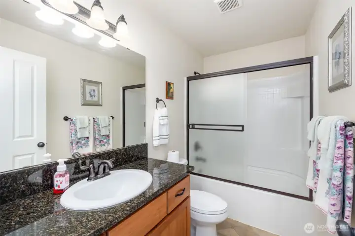 Upstairs full bathroom with plenty of storage and counterspace.