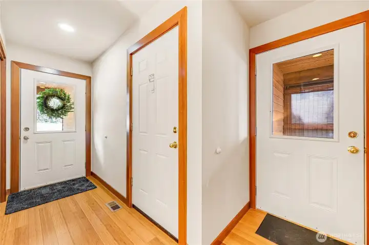Entry hall showing door to the garage and door to enclosed deck.