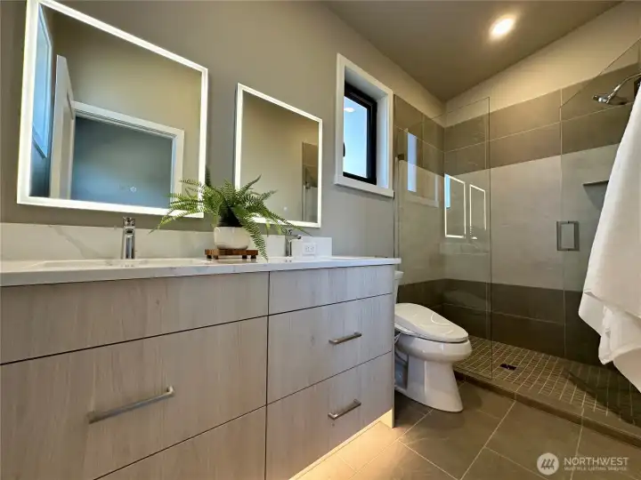 Primary Bath with custom features like light Up medicine cabinet mirrors and bidet.
