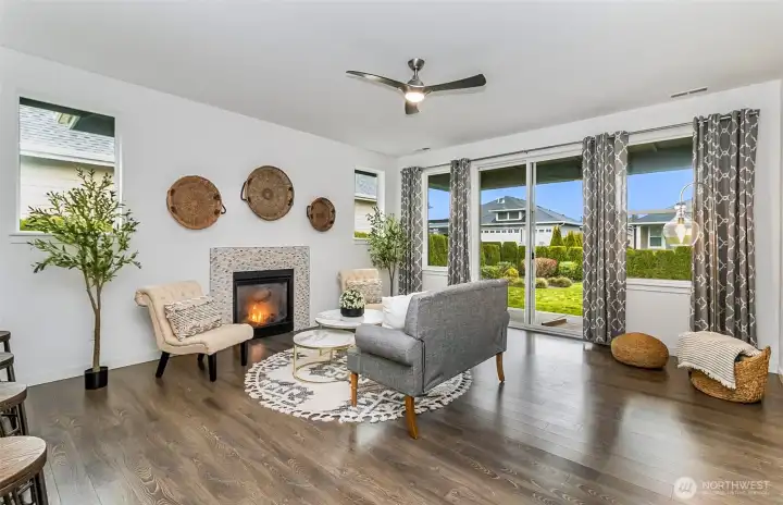 Living room with fireplace, leading to the back yard