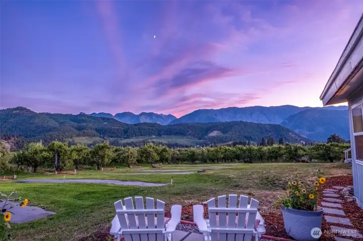 Panoramic Cascade Views: Relax on the expansive half wrap-around deck overlooking lush orchards. The perfect spot for morning coffee or sunset entertaining just minutes from the Bavarian Village.
