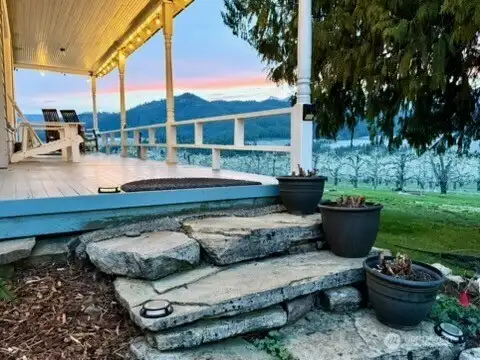 Panoramic Cascade Views: Relax on the expansive half wrap-around deck overlooking lush orchards. The perfect spot for morning coffee or sunset entertaining just minutes from the Bavarian Village.
