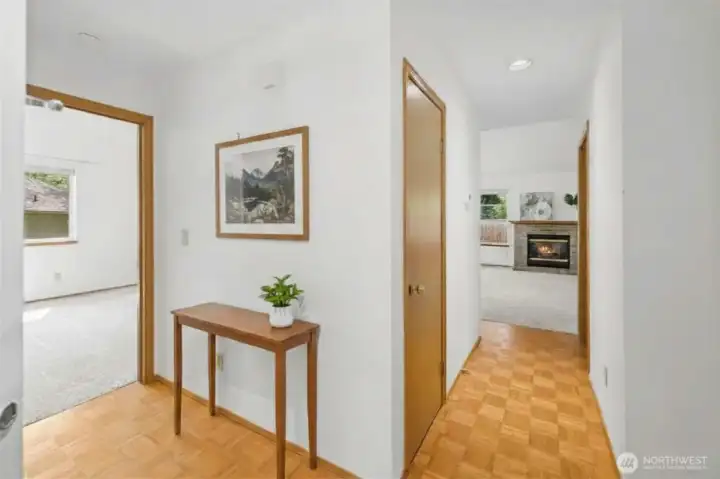 Parquet hardwoods in a welcoming foyer for a private feel. (virtually staged)