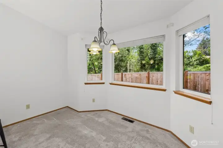 Dining area features a peaceful greenspace view for relaxing meals and conversation.