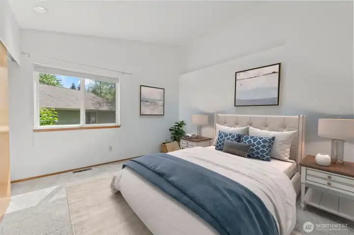 Primary bedroom is roomy with two closets and an en suite bath.(virtually staged)