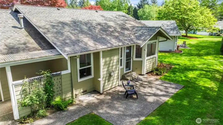 Backyard offers patio space for grilling or relaxing... and a beautiful green view!