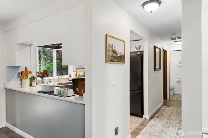 Down the hall toward your laundry room, 1/2 bath and private 1-car garage entrance into the home.