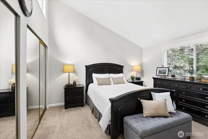 Primary bedroom with vaulted ceilings and motorized blinds on the upper windows. Double closets for all your personal items.
