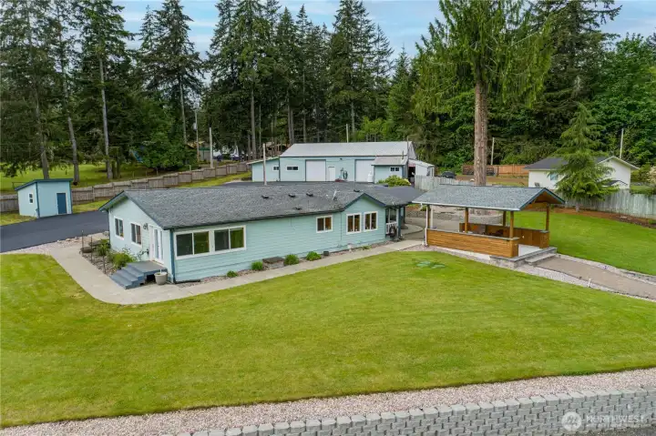 Home and gazebo, the detached building with the rec room, commercial kitchen and smoker room behind