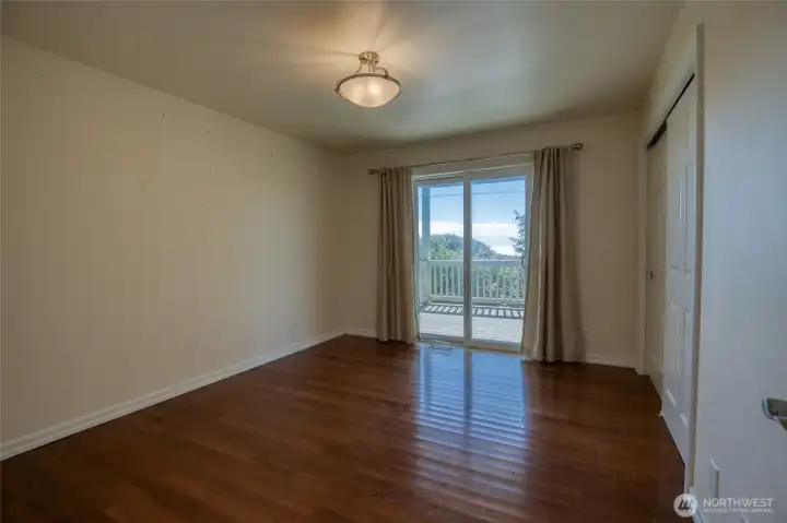 Downstairs (ground level) are two bedrooms with sliding glass doors.