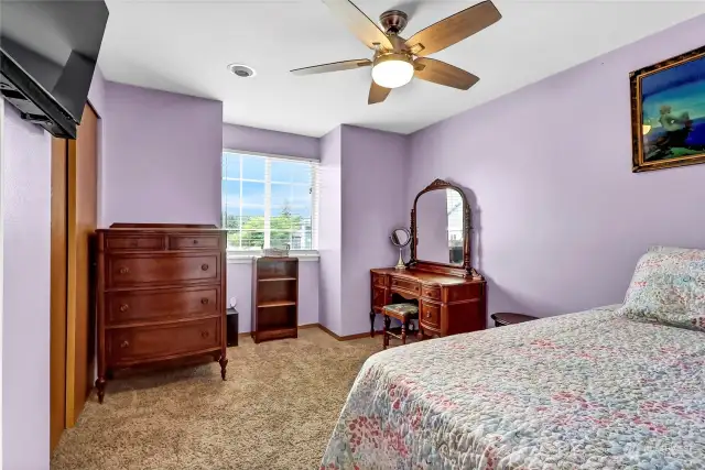 One of the three secondary bedrooms.  All bedrooms are nice sized and ready for you to move in. Ceiling fans abound in this home along with mounted tvs (all mounts willl stay).