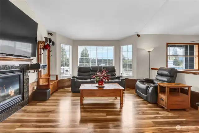 As you come through the front entry you enter into an amazing great room of a living room with gas fireplace and bay window. Glistening new engineered hardwoods abound.