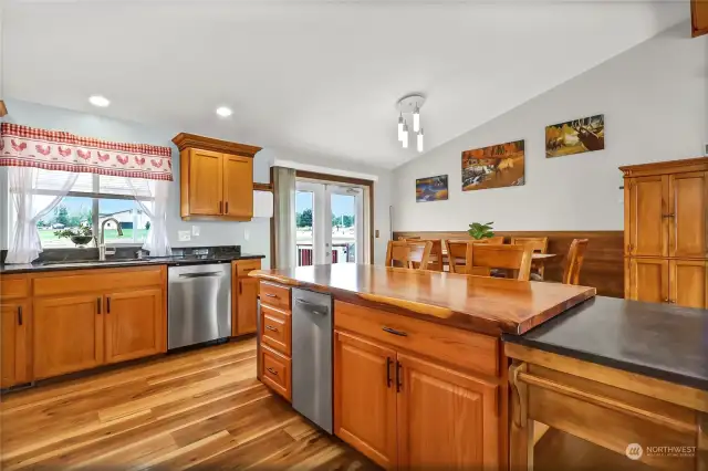 The kitchen is gourmet sized; counters and cabinets abound in this beauty.  All stainless steel appliances, canned and new lighting, beautiful decor. The dining room is seen in the back.