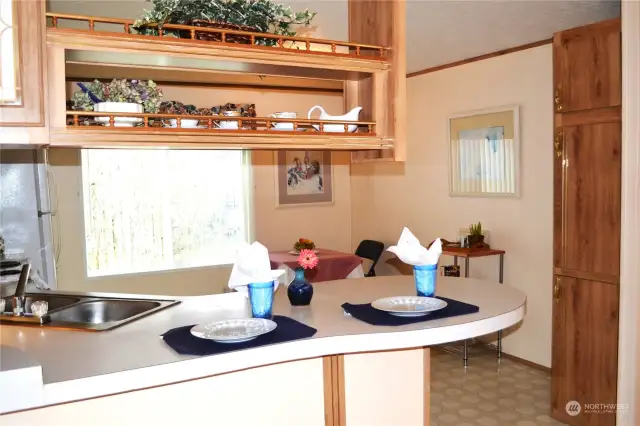 The kitchen is large enough for a table and extra shelves or a china cabinet.