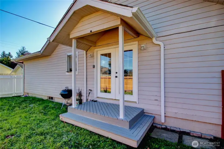 Fenced side yard with french doors into kitchen and gate access to front yard.