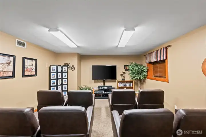 Movie theatre space is located in a corner of the large billiards room.