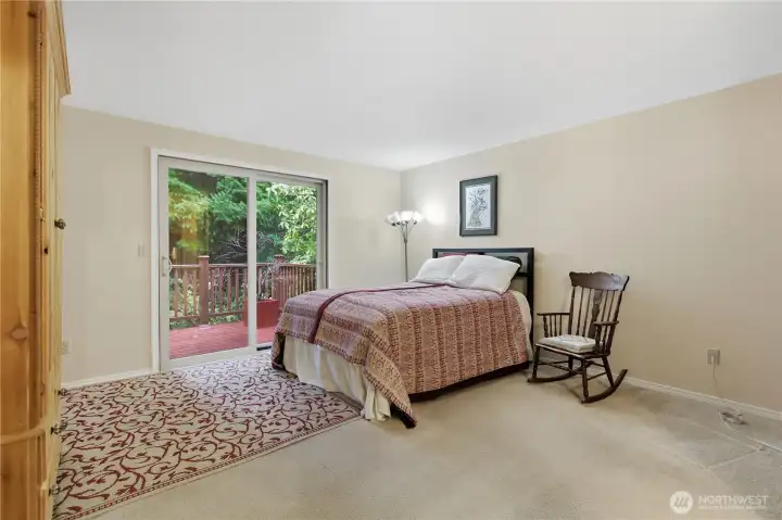 Spacious primary BR with slider to the back deck. Behind this property sits the University Place Homestead Park property for privacy.