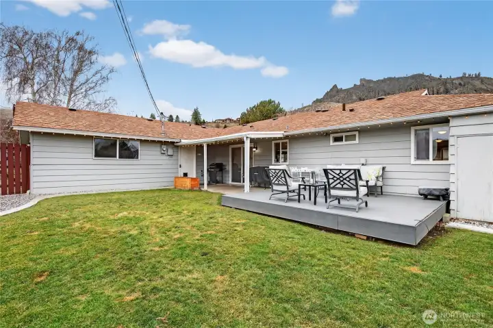 Back yard with covered patio, deck and grass