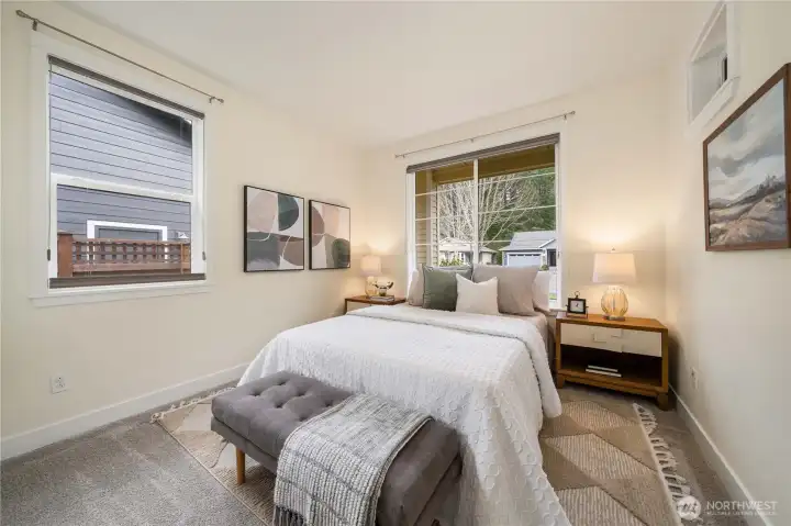 Guest bedroom offers privacy as it is at the opposite end of the home from the primary suite.