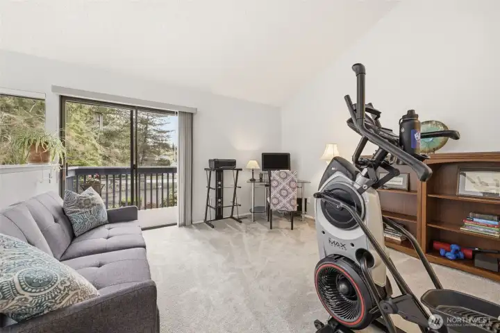 Upstairs spacious loft style bedroom 2 with deck overlooking private backyard and vaulted ceilings.