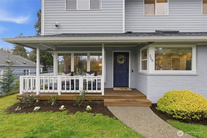 Charming front porch with fresh landscaping and great curb appeal