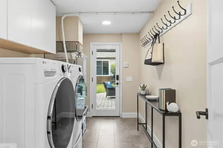 Spacious laundry room with extra storage and backyard access