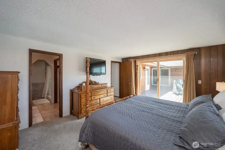 Main-level primary suite with private deck access and a spacious ensuite bath.