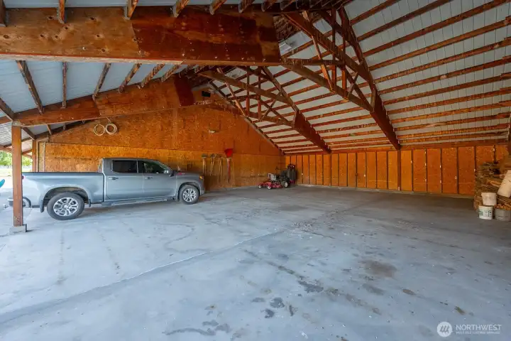 Additional covered storage bay provides flexibility for vehicles, trailers, or recreational equipment.
