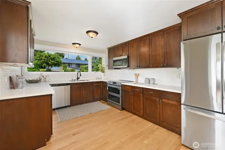 Updated kitchen with stainless appliances, quartz counters & hardwood floors Updated kitchen with stainless appliances, quartz counters & hardwood floors