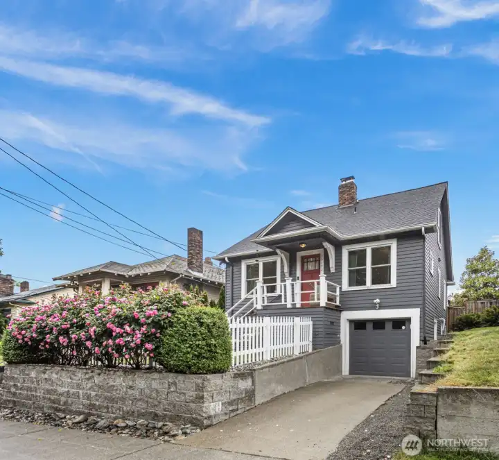Live at the Center of one of Seattle's Most Vibrant Neighborhoods. Elevated from the street for privacy with a beautiful colored hedge to enjoy the front low maintenance turf yard. Private driveway and attached garage.
