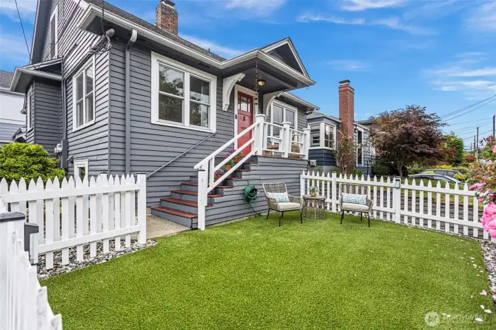 Low-maintenance turf front yard with full fencing, providing a private and easy-care outdoor space for relaxation, play, or pets.