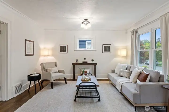 Period trim and baseboards showcase the home's timeless Craftsman appeal. The spacious living room provides ample wall space for art, media, or personalized furnishings.