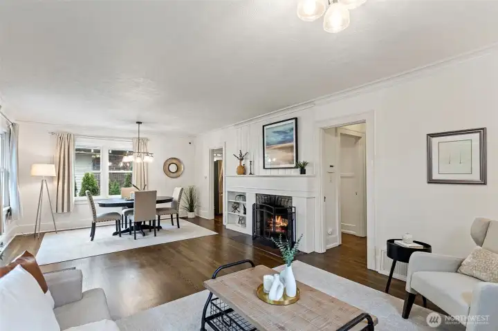 Spacious and light filled living and dining rooms centered around a wood fireplace with period built-ins, adds to the charm.