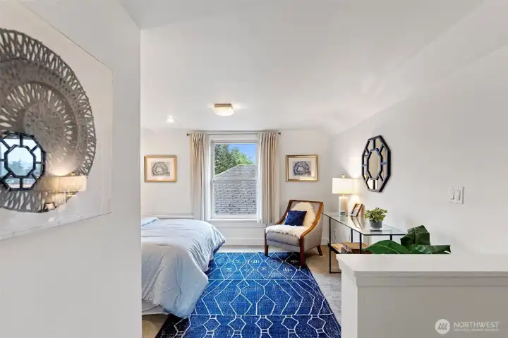 Spacious primary ensuite, created from the conversion of two bedrooms in 2015, offering an expansive retreat with a walk-in closet and abundant room to relax. Hardwood and/or fir flooring may be present beneath the carpet on the stairs and in the bedroom.