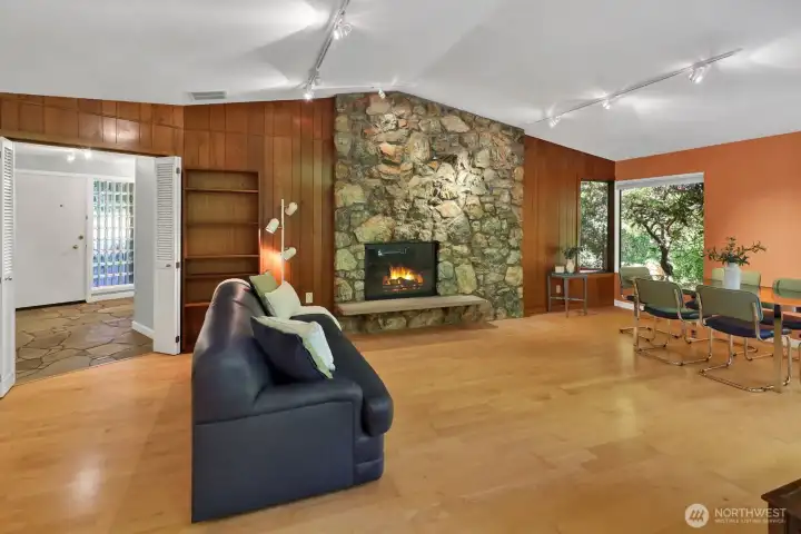 Living room is expansive with formal dining looking to the glass block front entry.