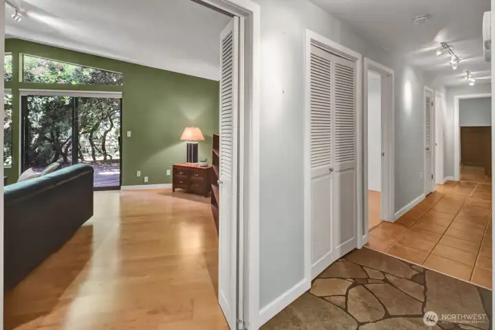 Entry looking into the living room and tile down the hallway, with the bedrooms have engineered wood floors.