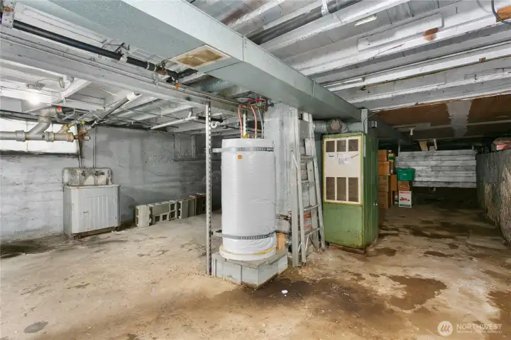 Unfinished basement. This houses the hotwater tank and furnace. Great tool/workshop area and storage. Unfinished basement. This houses the hotwater tank and furnace. Great tool/workshop area and storage.