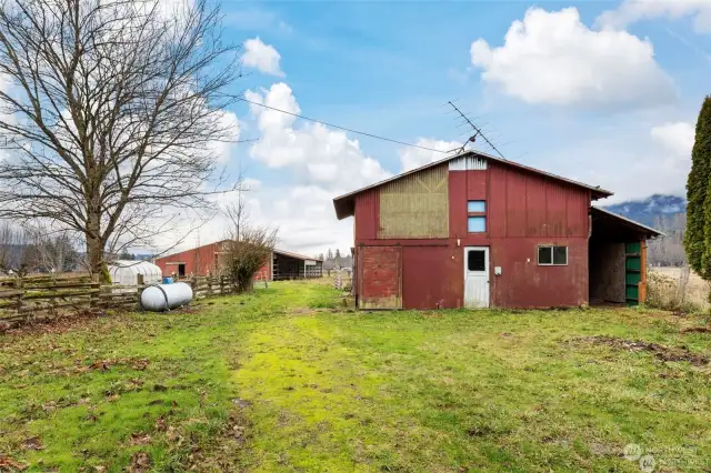 Looking east at the large workshop with the barn seen in the back. Workshop also has power!